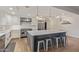 Bright kitchen featuring stainless steel appliances, an island with stool seating, and pendant lighting at 6231 E Desert Cove Ave, Scottsdale, AZ 85254