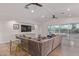 Bright living room boasts hardwood floors, a neutral sofa, and glass doors leading to the outdoor pool at 6231 E Desert Cove Ave, Scottsdale, AZ 85254