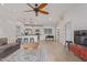Open-concept living area with tile flooring, ceiling fan, and kitchen view at 6231 E Desert Cove Ave, Scottsdale, AZ 85254