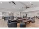 Comfortable living room features a large sectional, modern lighting, hardwood floors, and an open concept at 6231 E Desert Cove Ave, Scottsdale, AZ 85254