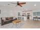 Bright living room featuring a ceiling fan, open kitchen, and tile flooring at 6231 E Desert Cove Ave, Scottsdale, AZ 85254