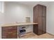 Office featuring ample desk space, dark wood cabinets, and a 'Laundry the never ending story' sign at 6231 E Desert Cove Ave, Scottsdale, AZ 85254