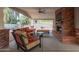 Covered patio features brick fireplace, ceiling fan and comfortable seating at 6231 E Desert Cove Ave, Scottsdale, AZ 85254