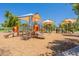 Playground features slides, ladders, and protective sunshades, creating a safe and fun area at 6231 E Desert Cove Ave, Scottsdale, AZ 85254
