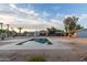Backyard pool with views of the home, palm trees, and blue skies at 6231 E Desert Cove Ave, Scottsdale, AZ 85254