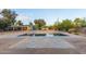 Backyard pool with stone tile, surrounded by trees, and a partial view of the house at 6231 E Desert Cove Ave, Scottsdale, AZ 85254