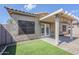 The backyard is equipped with artificial grass, a covered patio with lighting, and patio furniture for relaxing at 6317 S Kimberlee Way, Chandler, AZ 85249