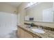The bathroom features a tub/shower combo, granite countertop and a decorative mirror above the sink at 6317 S Kimberlee Way, Chandler, AZ 85249