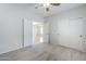This bedroom features neutral colors, ceiling fan and a view into another room through double doors at 6317 S Kimberlee Way, Chandler, AZ 85249