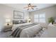 Cozy bedroom featuring a neutral color palette, plush bedding, and large window with shutters for natural light at 6317 S Kimberlee Way, Chandler, AZ 85249