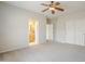Bright and open bedroom with carpet floors, ceiling fan, closet and open bathroom at 6317 S Kimberlee Way, Chandler, AZ 85249