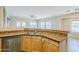 Kitchen with granite countertops, stainless steel dishwasher, and wood-look tile flooring at 6317 S Kimberlee Way, Chandler, AZ 85249