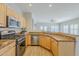 This kitchen features granite countertops, stainless steel appliances, and wood-look tile flooring at 6317 S Kimberlee Way, Chandler, AZ 85249