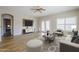 Bright, modern living room with wood floors, white walls, and stylish furnishings at 6317 S Kimberlee Way, Chandler, AZ 85249