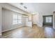 Bright, open living area with wood-look tile flooring and an elegant light fixture at 6317 S Kimberlee Way, Chandler, AZ 85249