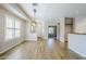 Open-concept living area with wood-look floors, neutral walls, and abundant natural light at 6317 S Kimberlee Way, Chandler, AZ 85249