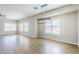 Spacious living room with wood-look tile, a modern chandelier, and bright natural lighting at 6317 S Kimberlee Way, Chandler, AZ 85249