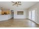 Open-concept living space with kitchen, wood-look tile flooring, and access to patio at 6317 S Kimberlee Way, Chandler, AZ 85249
