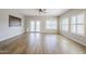 Spacious living room filled with natural light, wood-look tile flooring, and French doors at 6317 S Kimberlee Way, Chandler, AZ 85249