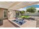 Relaxing back patio featuring a brick surface, pergola, and seating area for outdoor enjoyment at 6629 N Majorca E Way, Phoenix, AZ 85016