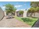 Lush backyard with a well-manicured lawn and patio area provides an ideal outdoor retreat at 6629 N Majorca E Way, Phoenix, AZ 85016