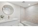 This bathroom features a single-sink vanity with quartz countertop, framed mirror, and shower-tub combo at 6629 N Majorca E Way, Phoenix, AZ 85016