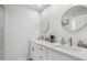 Bright bathroom features a double sink vanity with quartz countertops, framed mirrors, and bronze fixtures at 6629 N Majorca E Way, Phoenix, AZ 85016