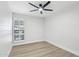 Neutral bedroom features wood-look floors, base trim, and a window with plantation shutters at 6629 N Majorca E Way, Phoenix, AZ 85016