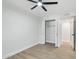 This bedroom has light-toned wood-look floors, closet, doorway, and a ceiling fan at 6629 N Majorca E Way, Phoenix, AZ 85016