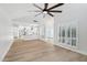 Bright, open-concept living space with wood flooring and shuttered windows at 6629 N Majorca E Way, Phoenix, AZ 85016
