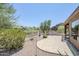Landscaped back yard with desert vegetation, block wall, and covered patio at 7094 E Palo Brea Dr, Gold Canyon, AZ 85118
