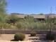 Desert backyard with rock landscaping, mountain views, and patio at 7094 E Palo Brea Dr, Gold Canyon, AZ 85118