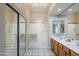 Bright bathroom featuring a double sink vanity, walk-in shower, and sliding door closet at 7094 E Palo Brea Dr, Gold Canyon, AZ 85118