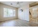 Light-filled bedroom with a window and plank floors at 7094 E Palo Brea Dr, Gold Canyon, AZ 85118