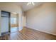 A bedroom with wood floors, a closet with mirrored doors, and a ceiling fan at 7094 E Palo Brea Dr, Gold Canyon, AZ 85118