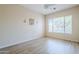 An empty bedroom features a large window and plank floors at 7094 E Palo Brea Dr, Gold Canyon, AZ 85118