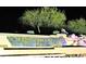 Nighttime view of the MountainBrook Village entrance sign with water feature at 7094 E Palo Brea Dr, Gold Canyon, AZ 85118