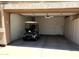 Clean garage with an abundance of built-in cabinets and a golf cart at 7094 E Palo Brea Dr, Gold Canyon, AZ 85118