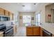 Functional kitchen with stainless appliances, wood cabinets, and a view of the outdoor scenery at 7094 E Palo Brea Dr, Gold Canyon, AZ 85118