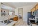 An open kitchen features tile floors, stainless steel appliances, and a view into the dining room at 7094 E Palo Brea Dr, Gold Canyon, AZ 85118