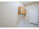 Laundry room equipped with cabinets and washer and dryer hookups at 7094 E Palo Brea Dr, Gold Canyon, AZ 85118