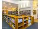 Community library with organized bookshelves, tables, and comfortable seating at 7094 E Palo Brea Dr, Gold Canyon, AZ 85118