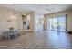 Open-concept living space featuring a dining area, wood floors, and sliding glass doors to the patio at 7094 E Palo Brea Dr, Gold Canyon, AZ 85118