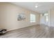 Spacious, well-lit living room with wood floors, a white door, and large windows at 7094 E Palo Brea Dr, Gold Canyon, AZ 85118