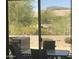 Covered patio features outdoor seating and views of desert landscaping and mountains in the distance at 7094 E Palo Brea Dr, Gold Canyon, AZ 85118