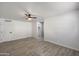 Spacious bedroom with tile floors, fresh paint, ceiling fan, closet, and entry to bathroom at 7101 N 36Th Ave # 102, Phoenix, AZ 85051