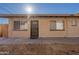 Tan apartment building with a security door, multiple windows, and a concrete walkway at 7101 N 36Th Ave # 102, Phoenix, AZ 85051