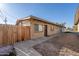 Exterior view of tan apartment building with security door and a wood fence on the side at 7101 N 36Th Ave # 102, Phoenix, AZ 85051