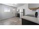 Modern kitchen includes stainless steel appliances, stone countertops, updated floors, and white walls at 7101 N 36Th Ave # 102, Phoenix, AZ 85051