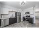 Modern kitchen with stainless steel appliances, gray cabinets, white walls, and wood look floors at 7101 N 36Th Ave # 102, Phoenix, AZ 85051